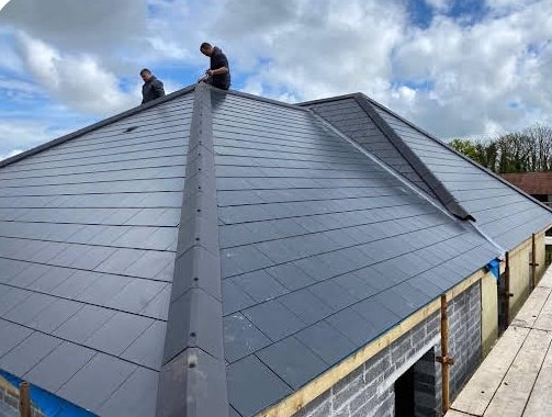 AH Roofing crew finishing a hip roof ridge